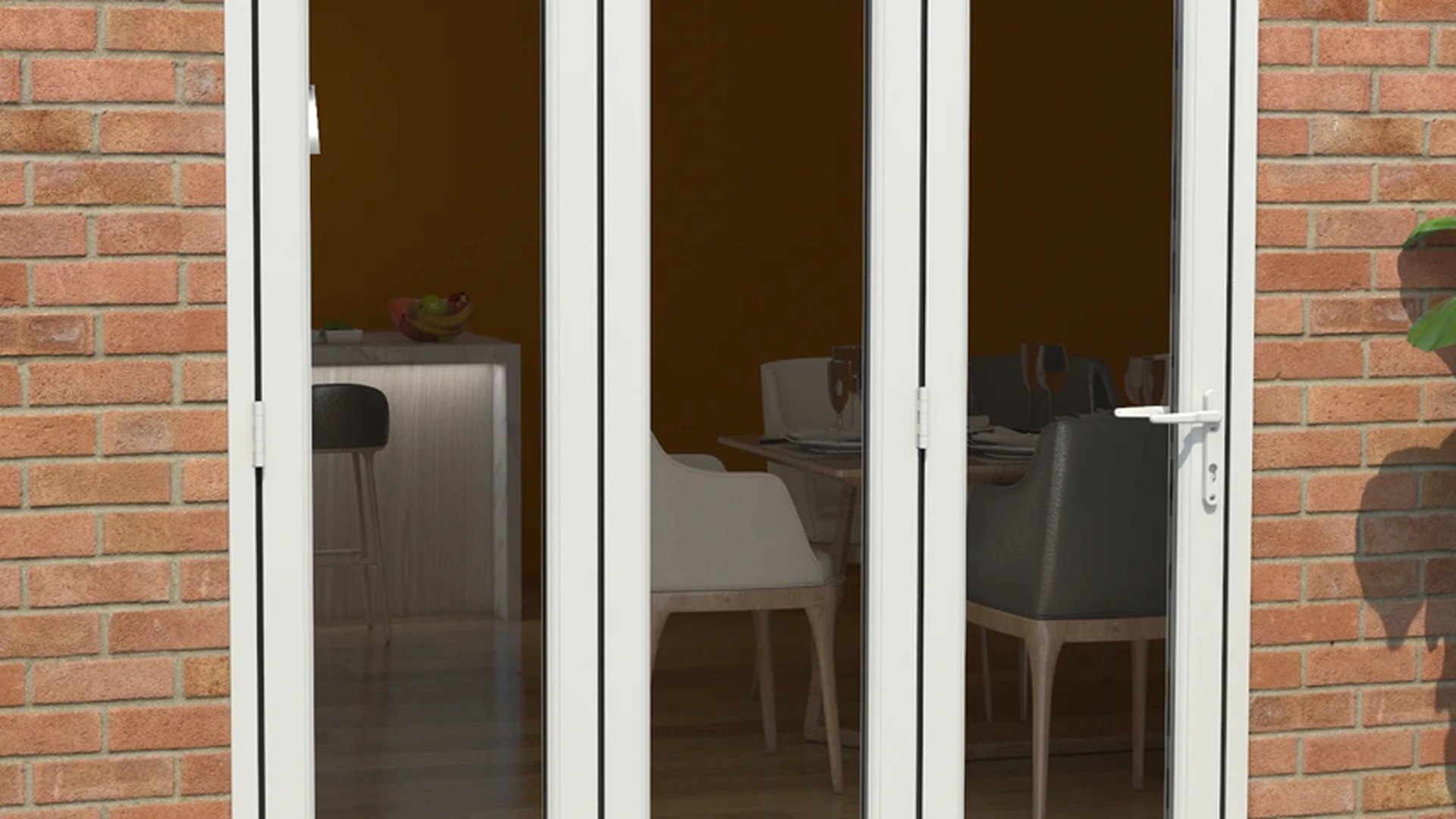A white uPVC folding door set closed across a brick elevation, photographed from outside with the interior visible through the glazing.