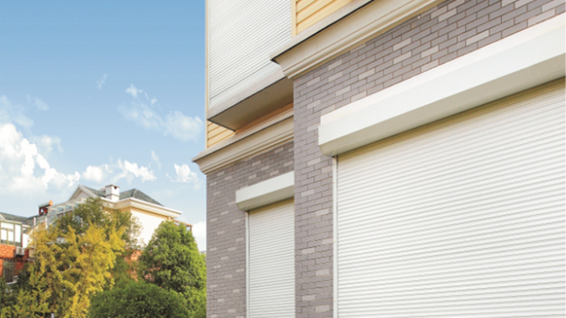 A shutter closed over a window in a brick and tile facade: the reveal, the sill and the guide are all visible, which is what a security assessment actually has to look at.