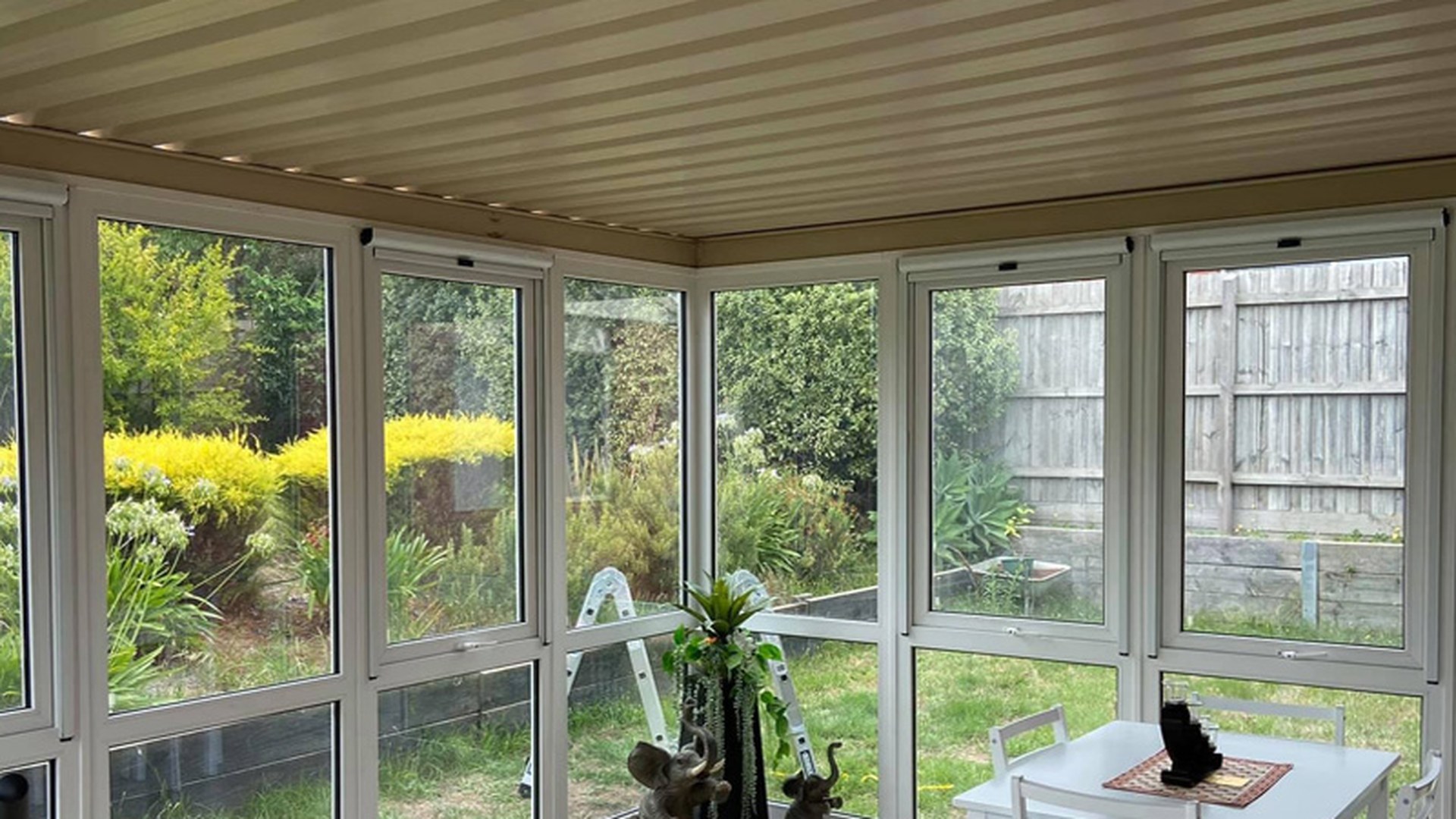 A sunroom glazed down to floor level: continuous low glass is the condition that pulls doors, side panels and low windows into one selection rule.