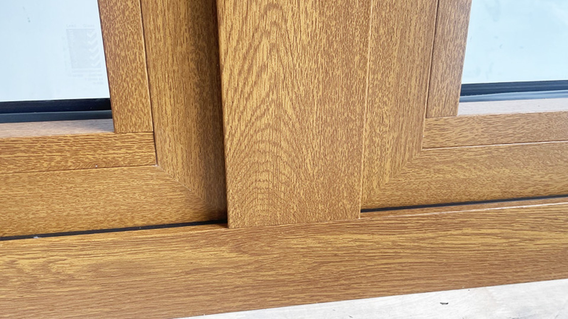 The rebate behind a glazing bead in close-up: an integral blind adds a cassette and a control to this depth, so the frame section decides whether the unit can take one.