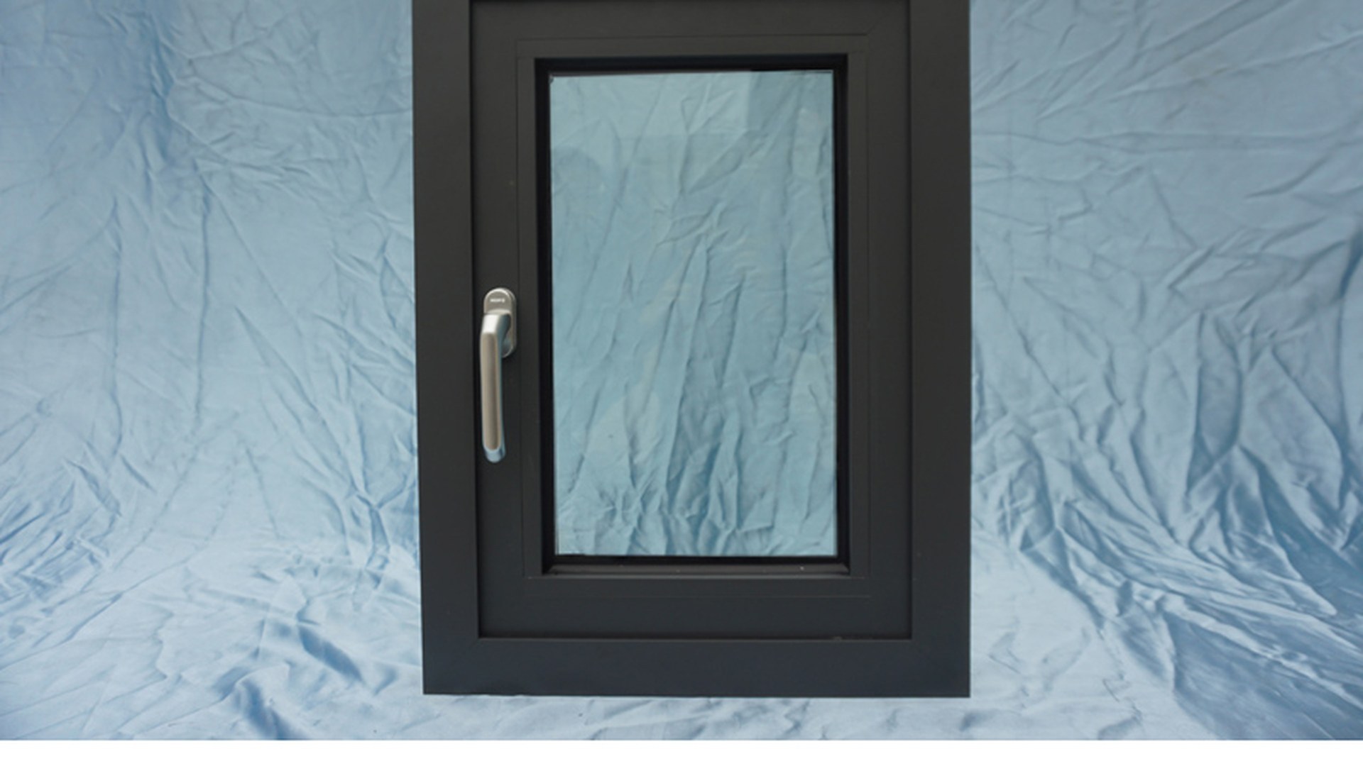 A finished casement on the packing bench: frame section, glazing bead and handle are the three parts an integral blind version changes, because the unit grows thicker and the control has to reach the frame.