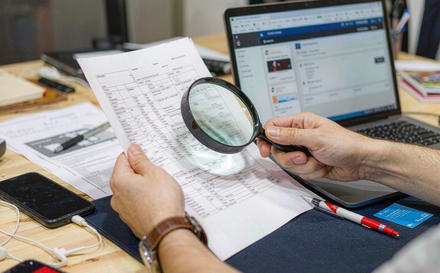 A magnifying glass over a freight invoice line items