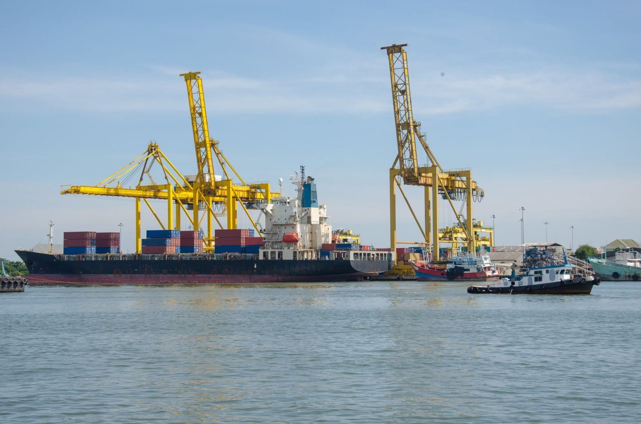 Container ship being loaded by cranes at a container terminal