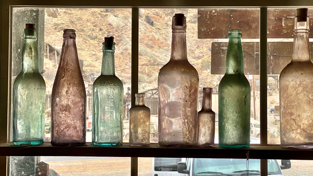 A collection of diverse wine bottles stored in a modern wine cooler fridge