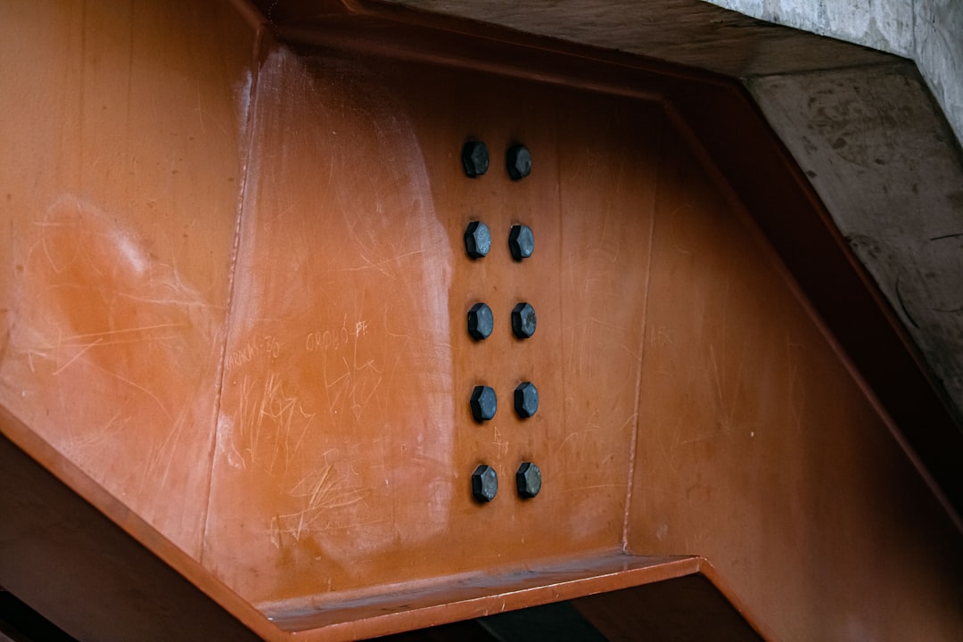 A built-in wine cooler with stylish wooden shelves and soft blue LED lighting.