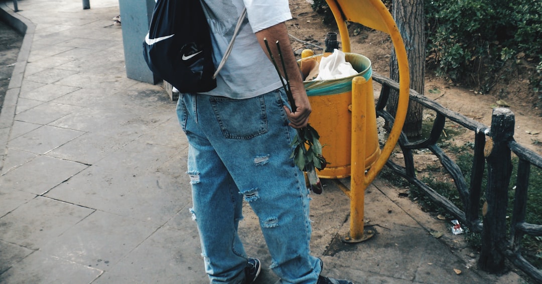 A person cleaning the clogged drain of a wine cooler