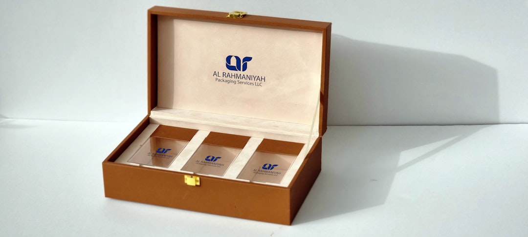 Close-up of a laser-engraved logo on a wooden humidor lid