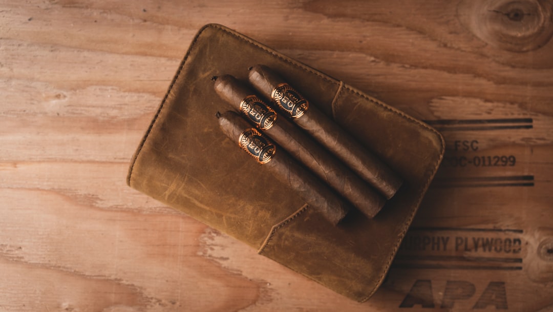 A rugged, black travel humidor holding five cigars