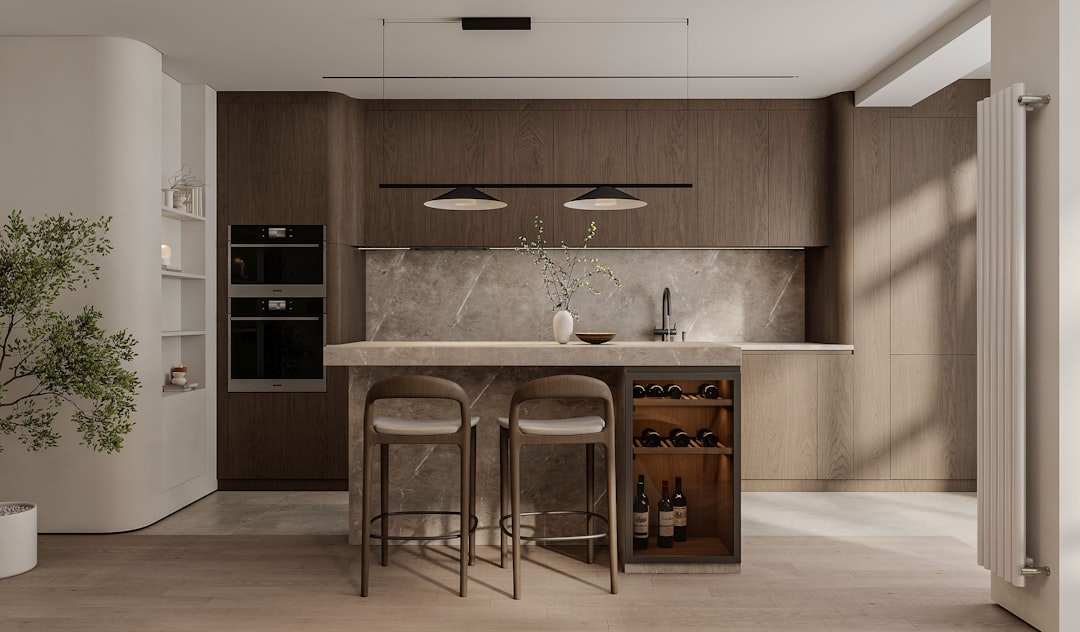 A stylish dark wine cooler fridge integrated into a modern kitchen island.