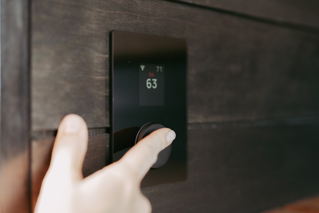 A close-up of a dual zone wine cooler's digital temperature controls showing two different settings.