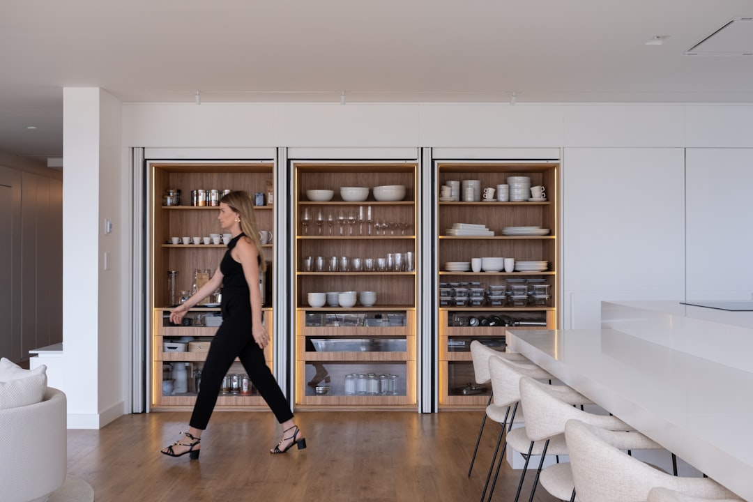 A freestanding single-zone wine cooler with classic wood shelving