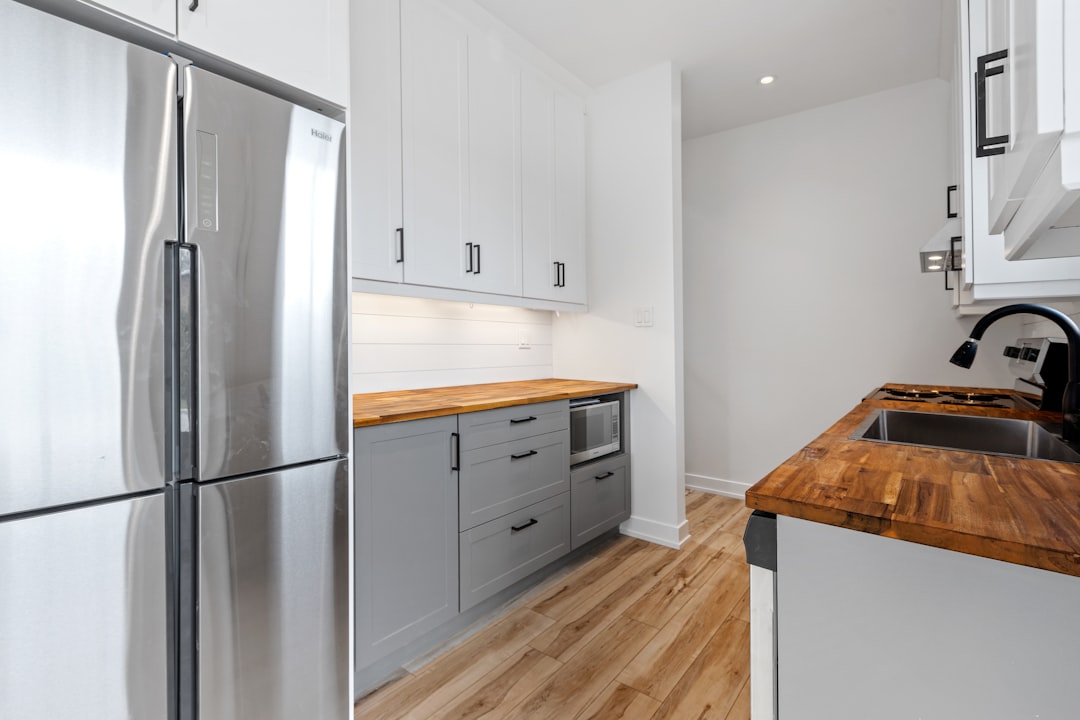 A sleek, stainless steel dry aging fridge integrated into a modern kitchen