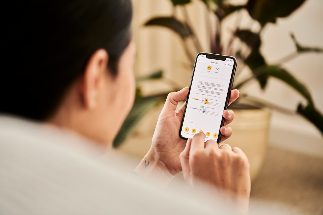 A person checking their smart humidor settings on a smartphone app