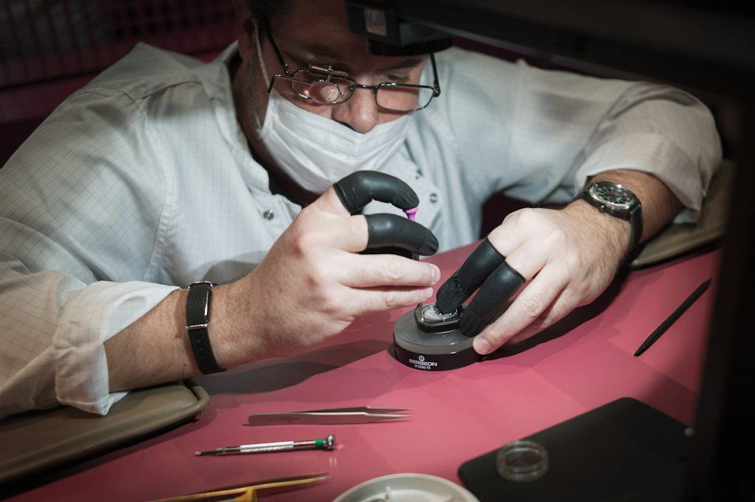 A craftsman carefully polishing the high-gloss finish of a new humidor