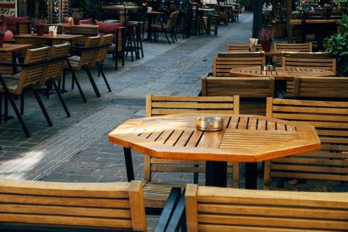 Outdoor restaurant dining area with commercial-grade metal furniture