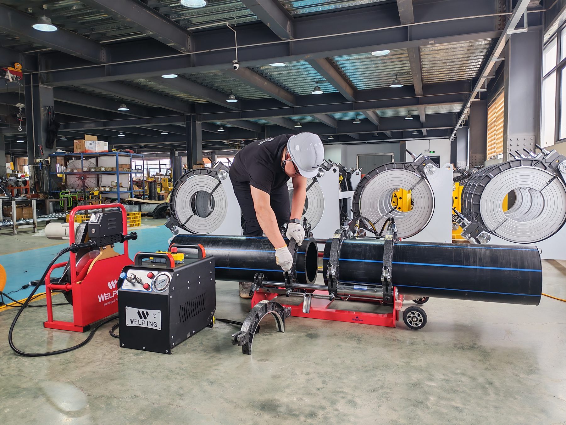 WELPING operator setting up a PE pipe butt fusion machine in the workshop