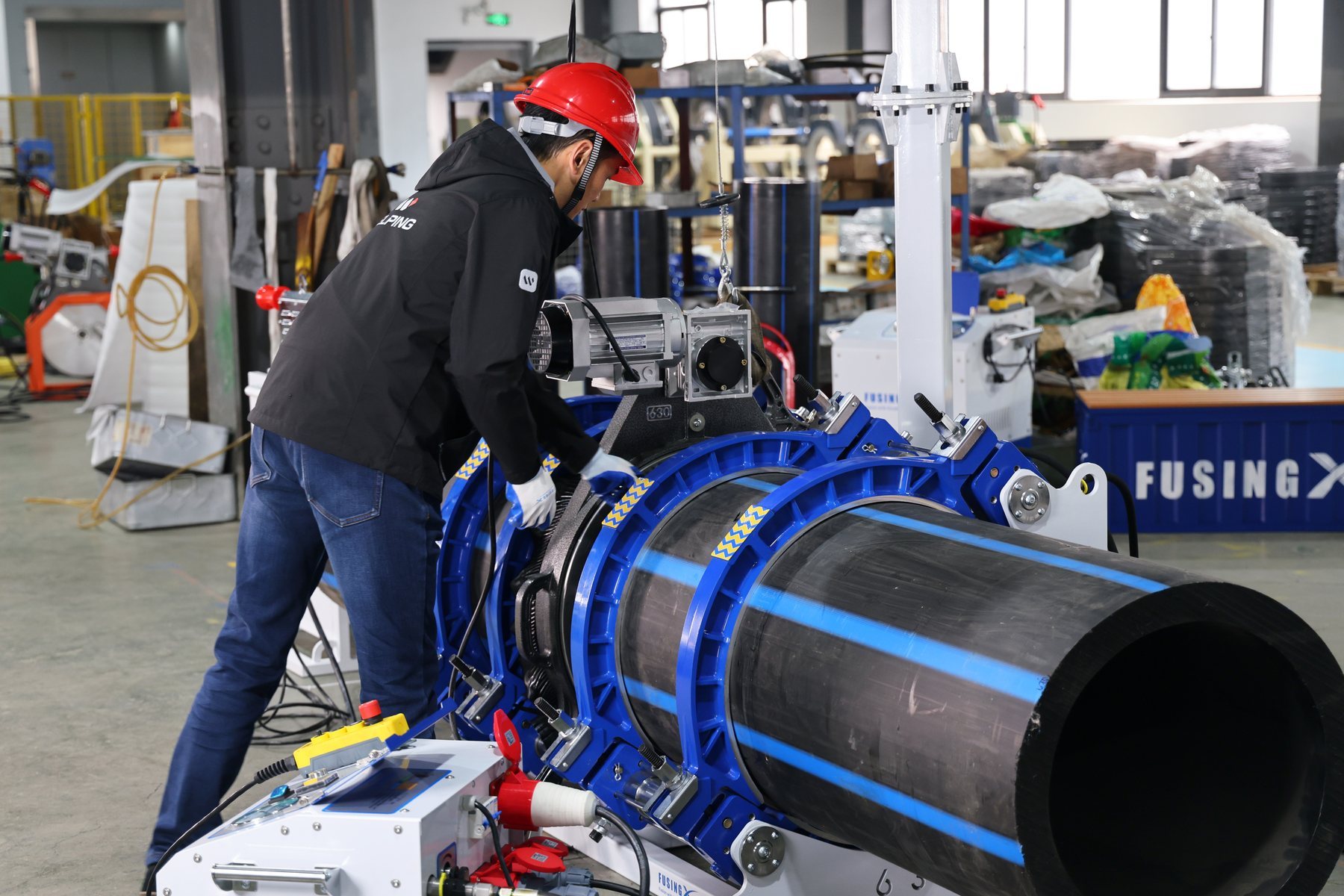 WELPING technician operating a large-diameter PE pipe butt fusion machine