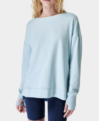 Women's sweatshirt has crossover back detail, side slits, and breathable sweat-wicking fabric.