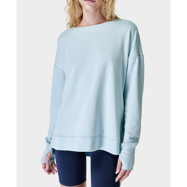 Women's sweatshirt has crossover back detail, side slits, and breathable sweat-wicking fabric.