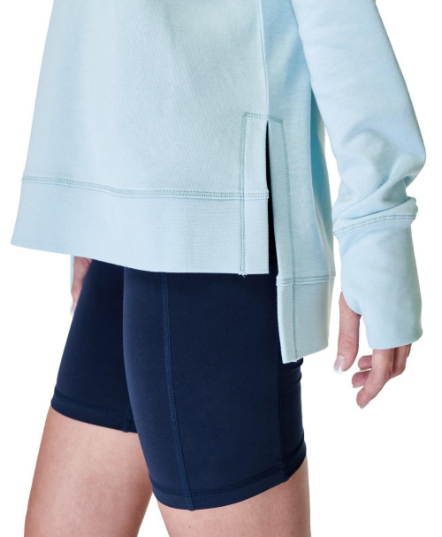 Women's sweatshirt has crossover back detail, side slits, and breathable sweat-wicking fabric.