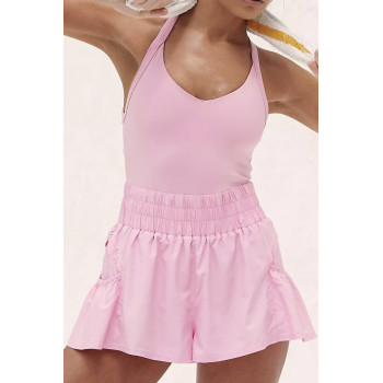 Sporty jumpsuit features a fitted top, loose fitting bottoms, short length, and slip-on design