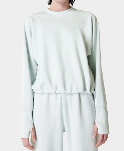 Women's crew neck sweatshirt with loose fit, elasticized hem and adjustable ties