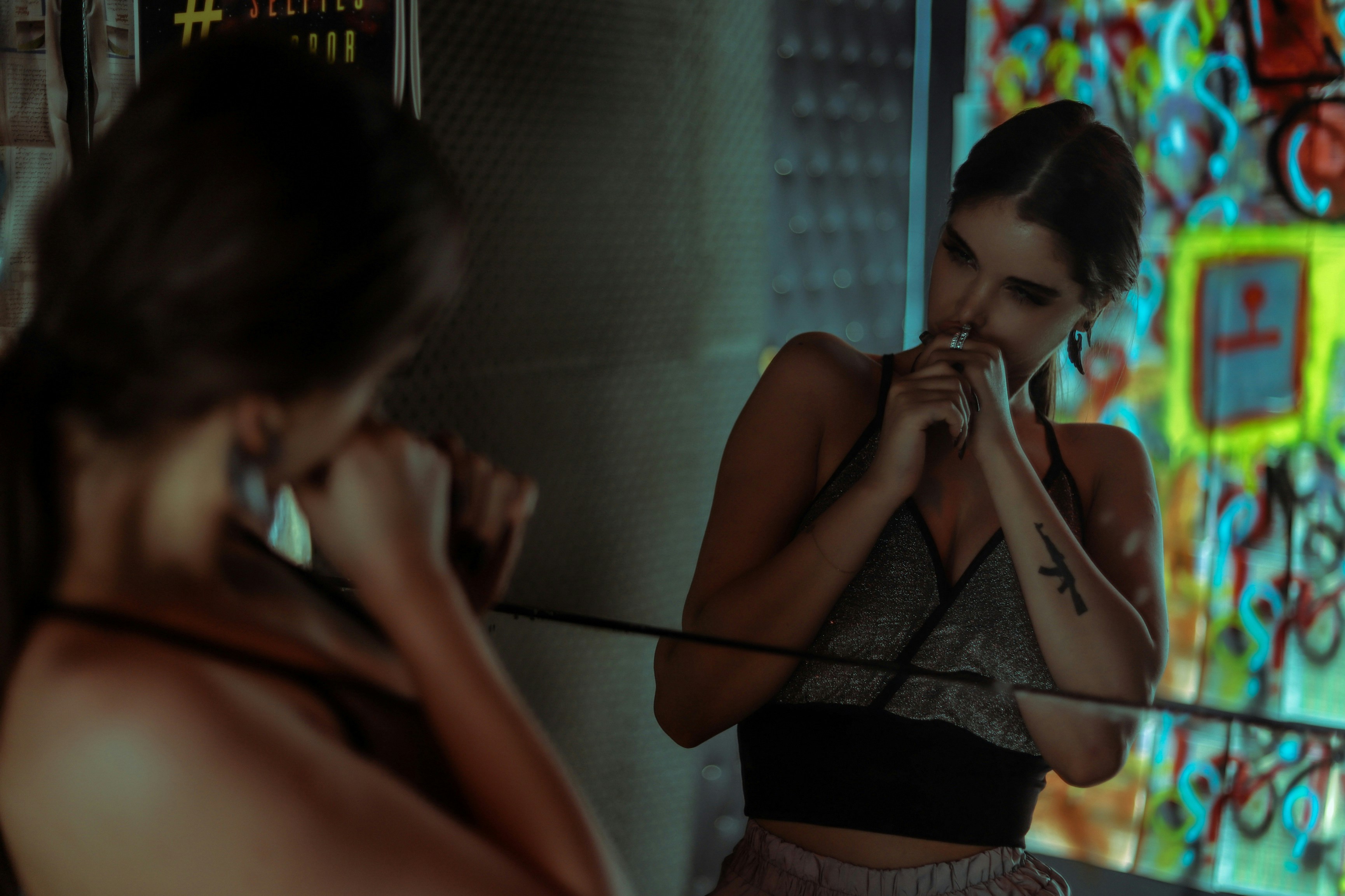 Woman checking the fit of her sports bra in a mirror