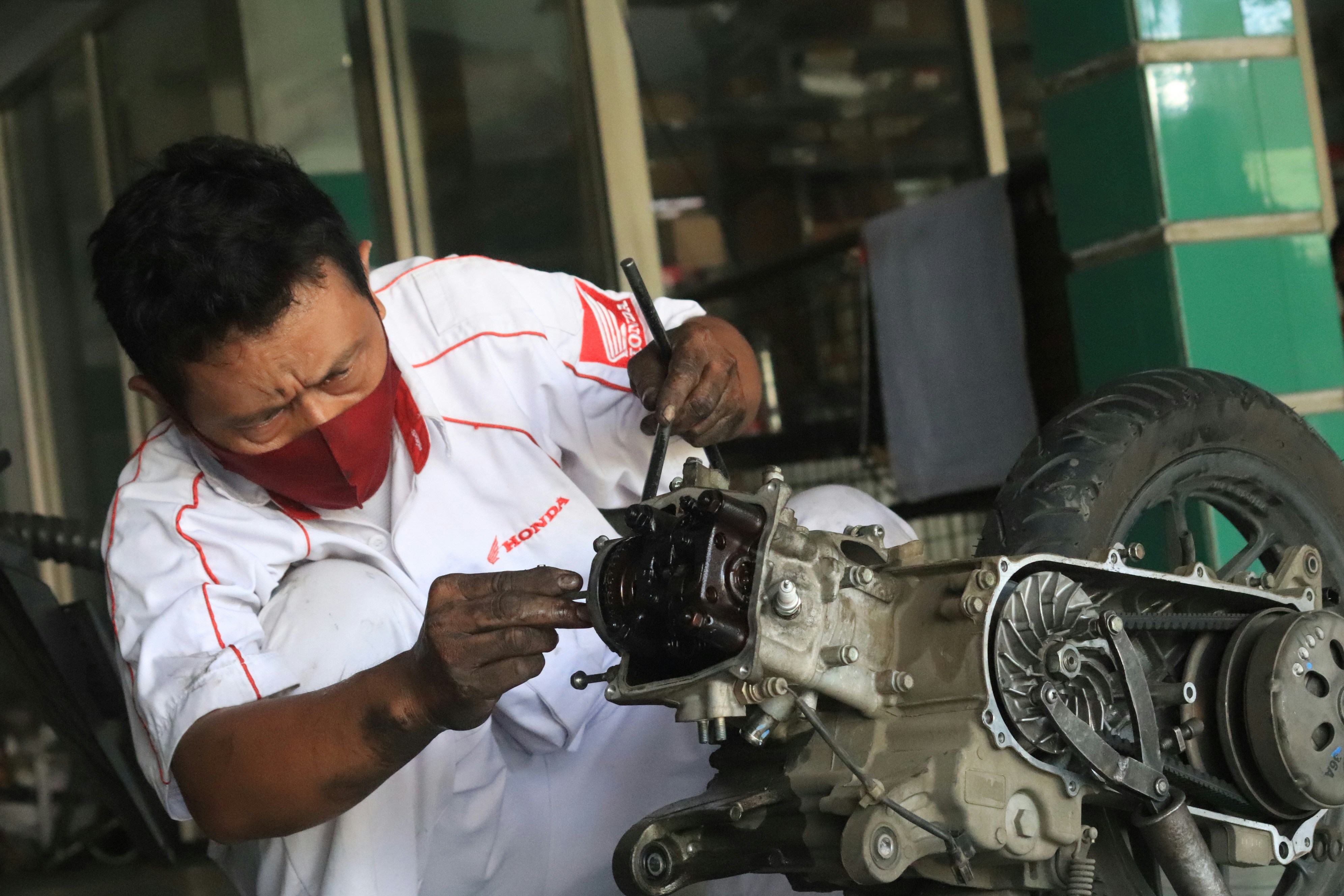 A mechanic inspecting a used Toyota engine