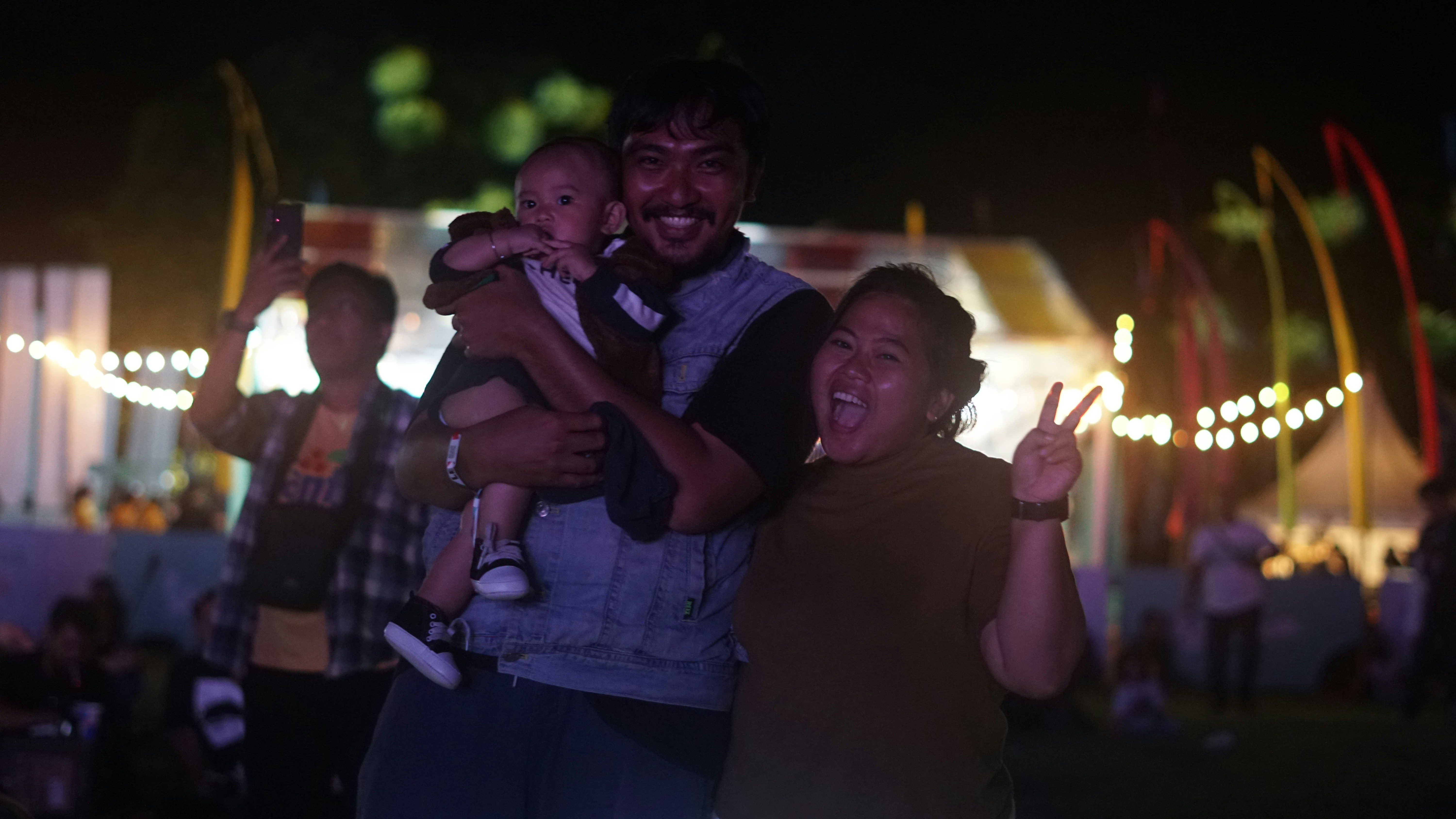 A family smiling next to their used Toyota SUV