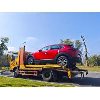 A red Mazda, blue sky and white clouds, and perfect sunshine.