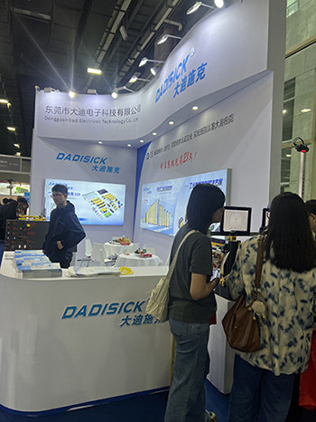 Visitors viewing DADISICK industrial safety sensors at exhibition