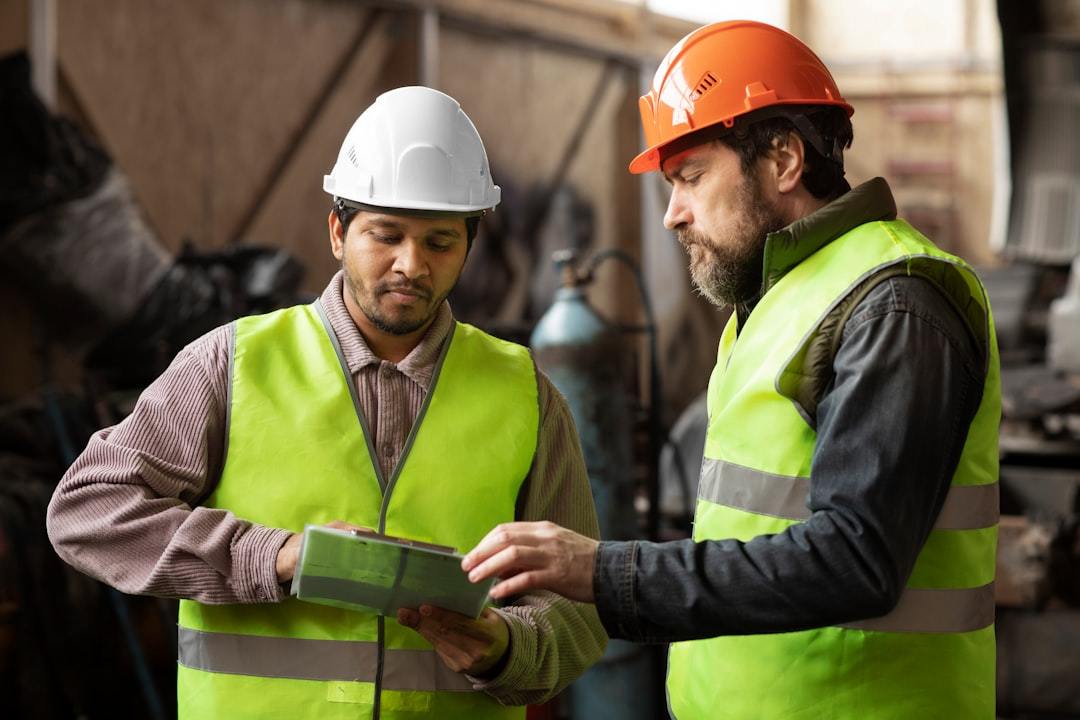 Safety engineers in protective gear inspecting factory equipment
