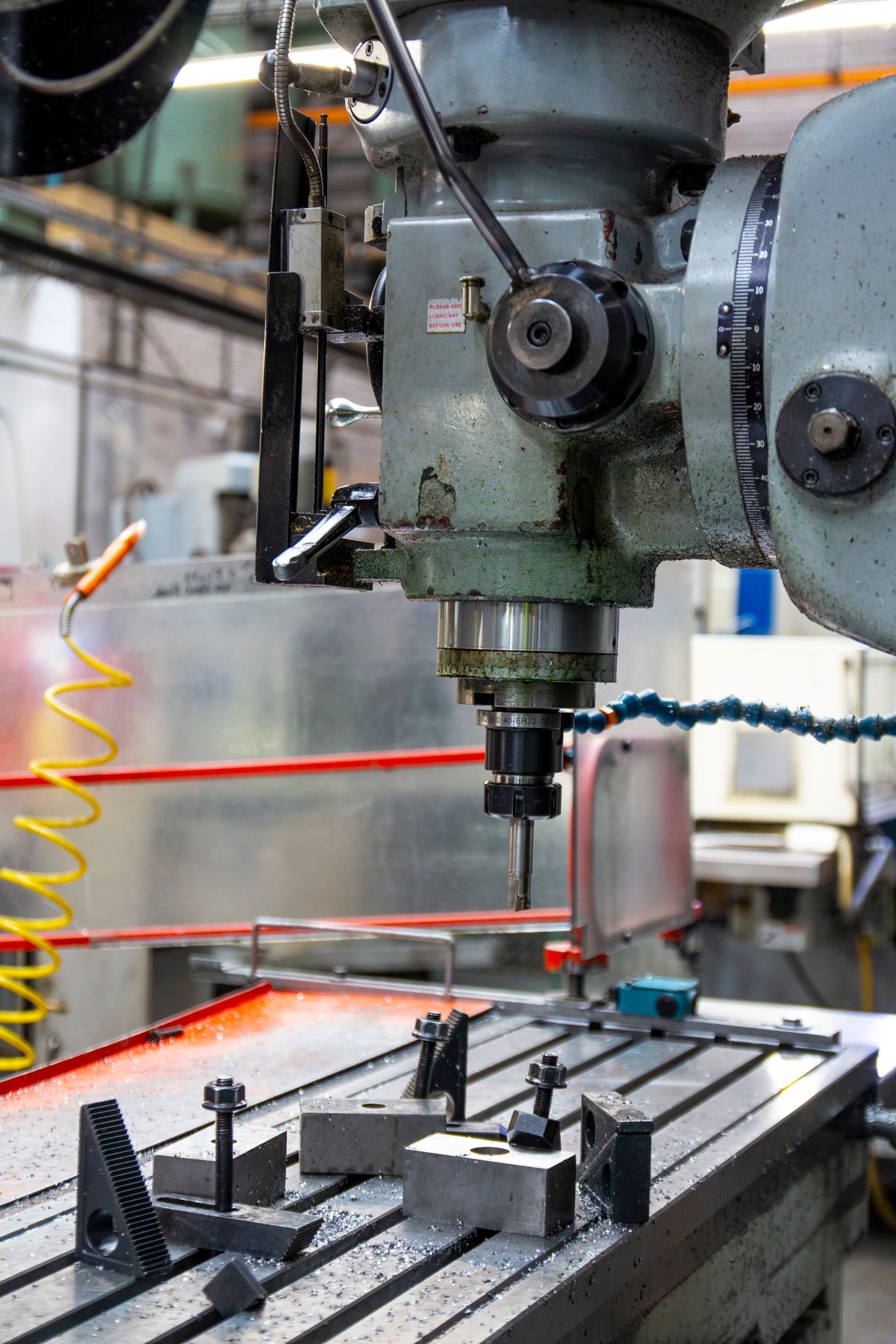 Milling machine with a clamped workpiece on the machine table in an industrial workshop