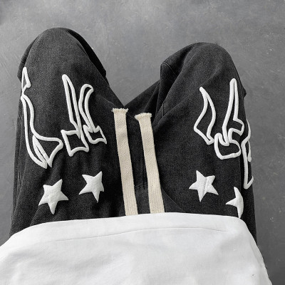 wholesale custom black ripped jeans mens with puff printing vendor | mens jeans manufacturers