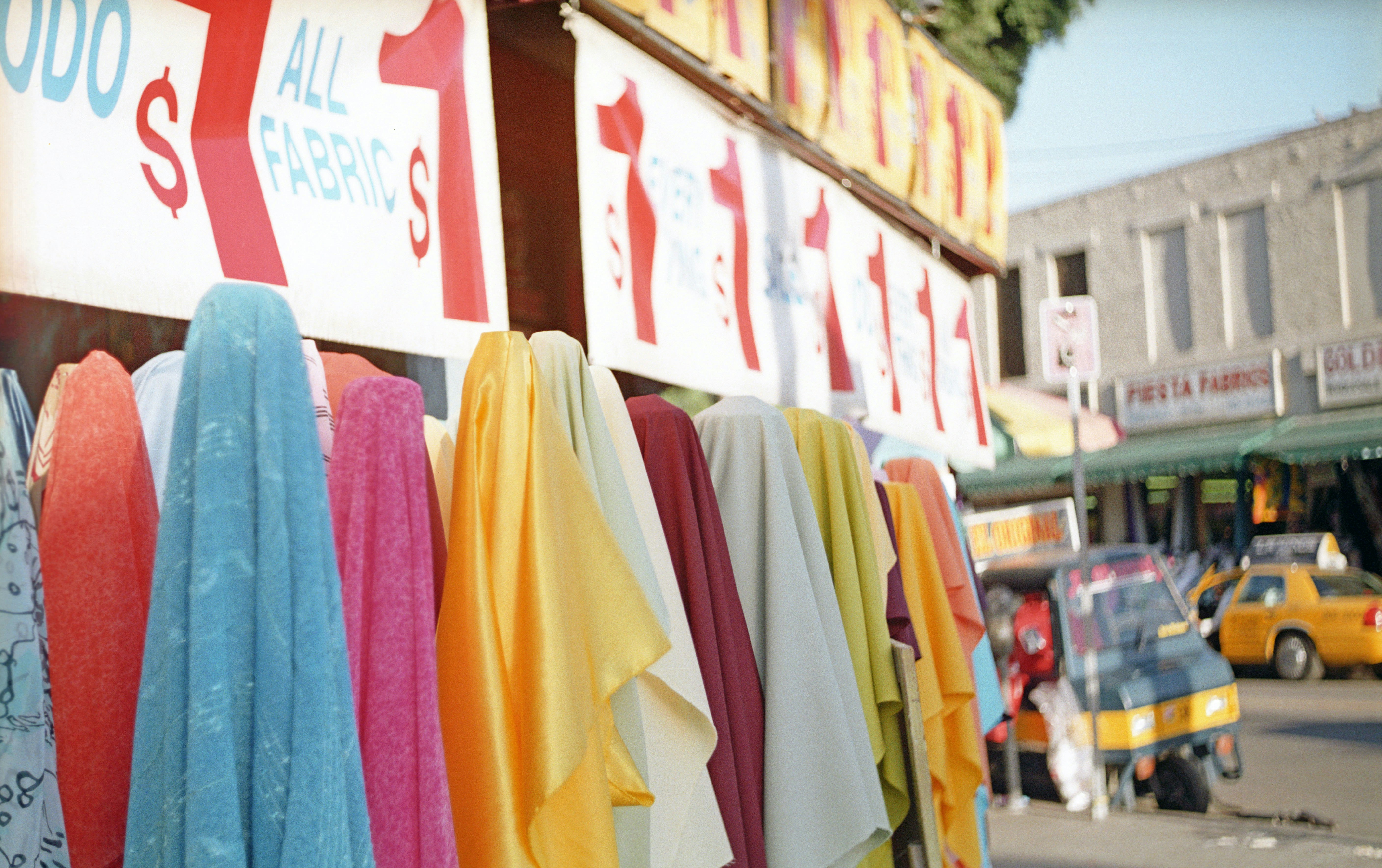 A display of various custom apparel items for a corporate event, including t-shirts, hoodies, and hats.