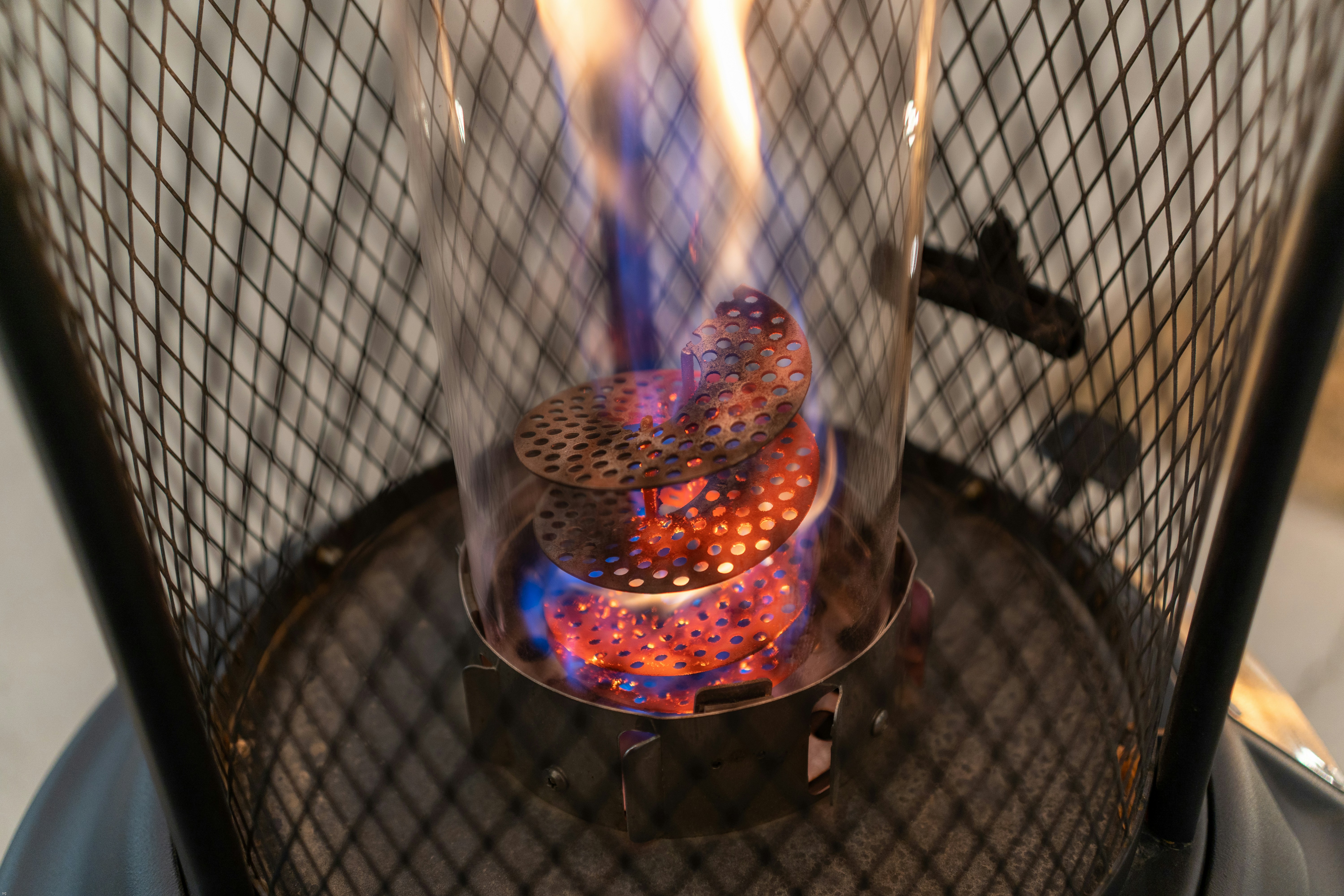 A modern five-burner gas hob with continuous cast-iron grates.