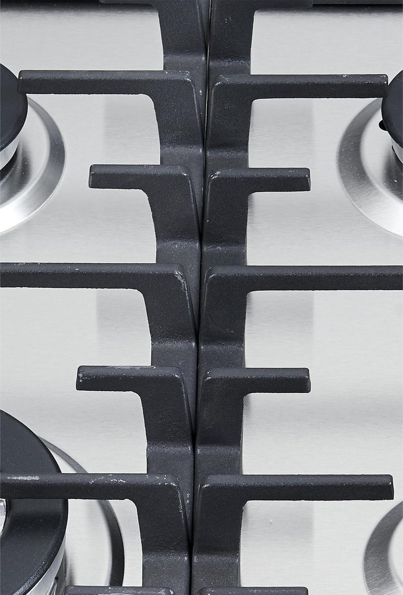 Stainless steel built-in gas hob with four burners and a wok burner in a modern kitchen