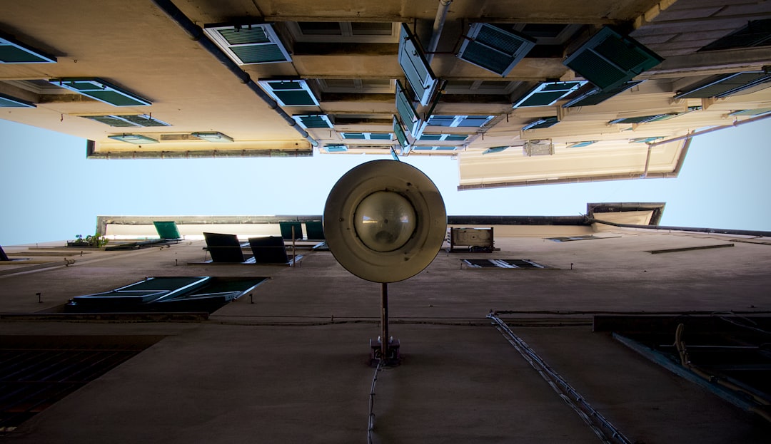 A durable commercial electric floor fan in a workshop setting