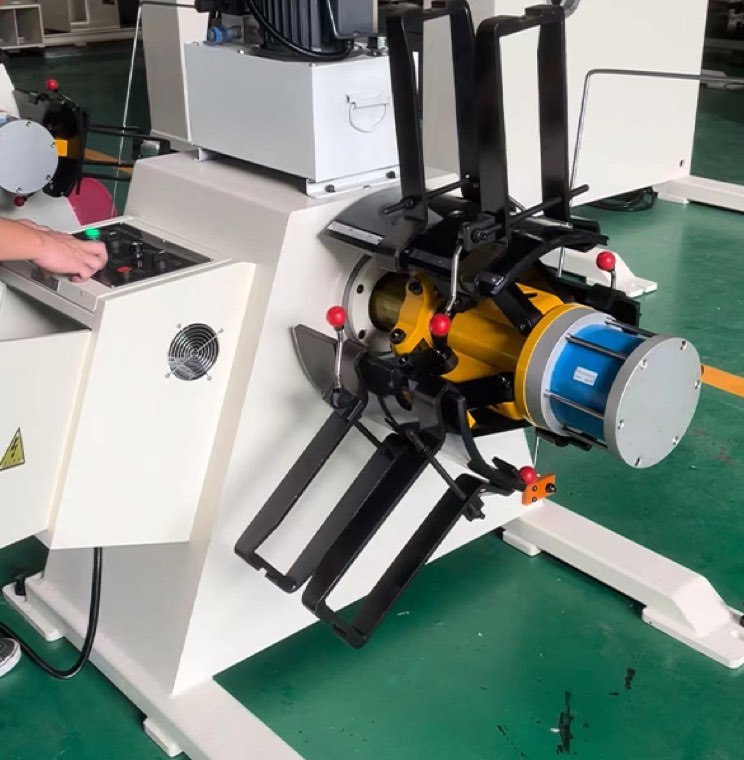 Steel coil being positioned on a decoiler mandrel ahead of a coil-fed stamping line