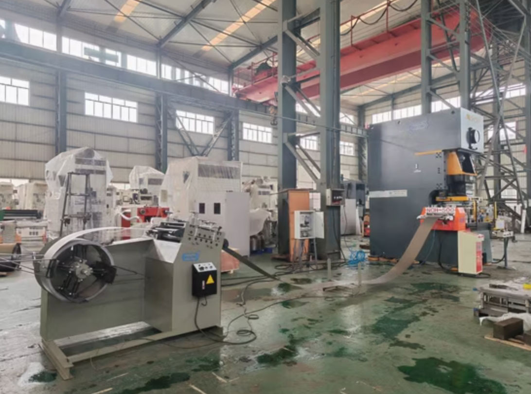 Galvanized coil being fed into a progressive die for solar bracket stamping
