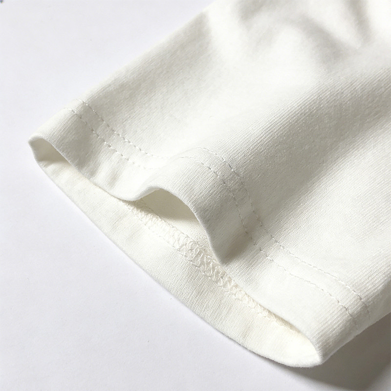 Relaxed oversized fit with clean, reinforced sleeve hems and a classic crew neckline. Dual-sided embroidery details add depth, while the neutral off-white base keeps the bold anime graphic the center of attention.