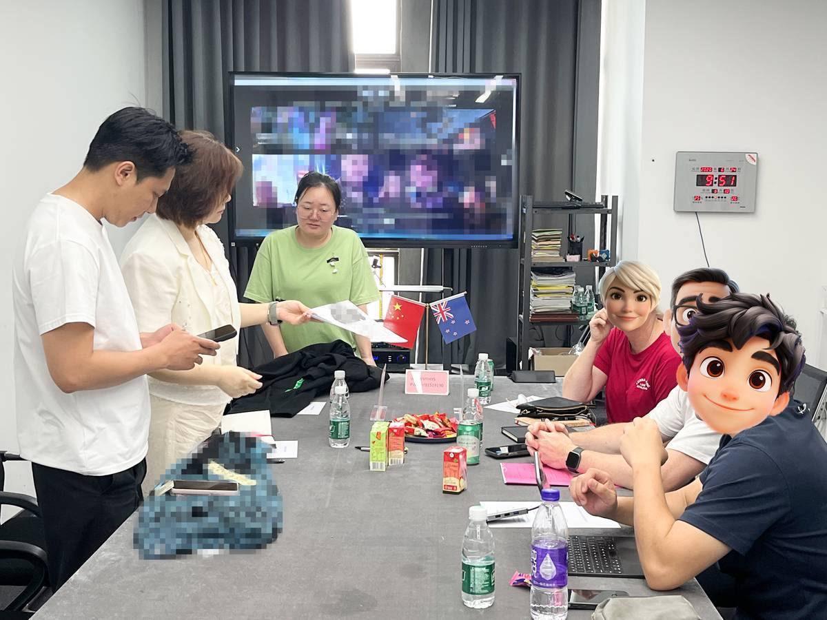 New Zealand client inspecting garment techniques at Touches Dark factory