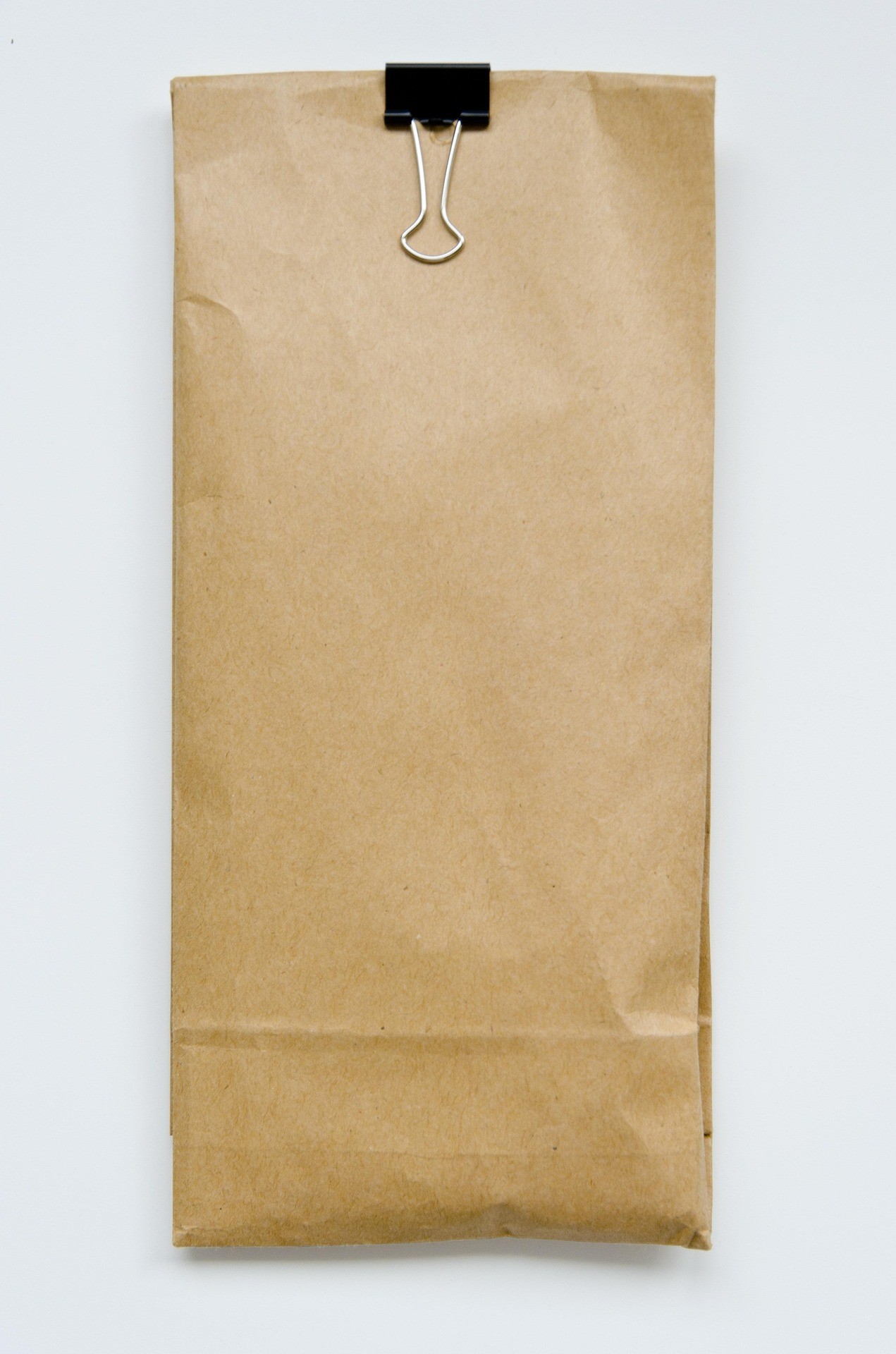 Eco-friendly compostable paper bag with green leaf symbolizing sustainable packaging solution