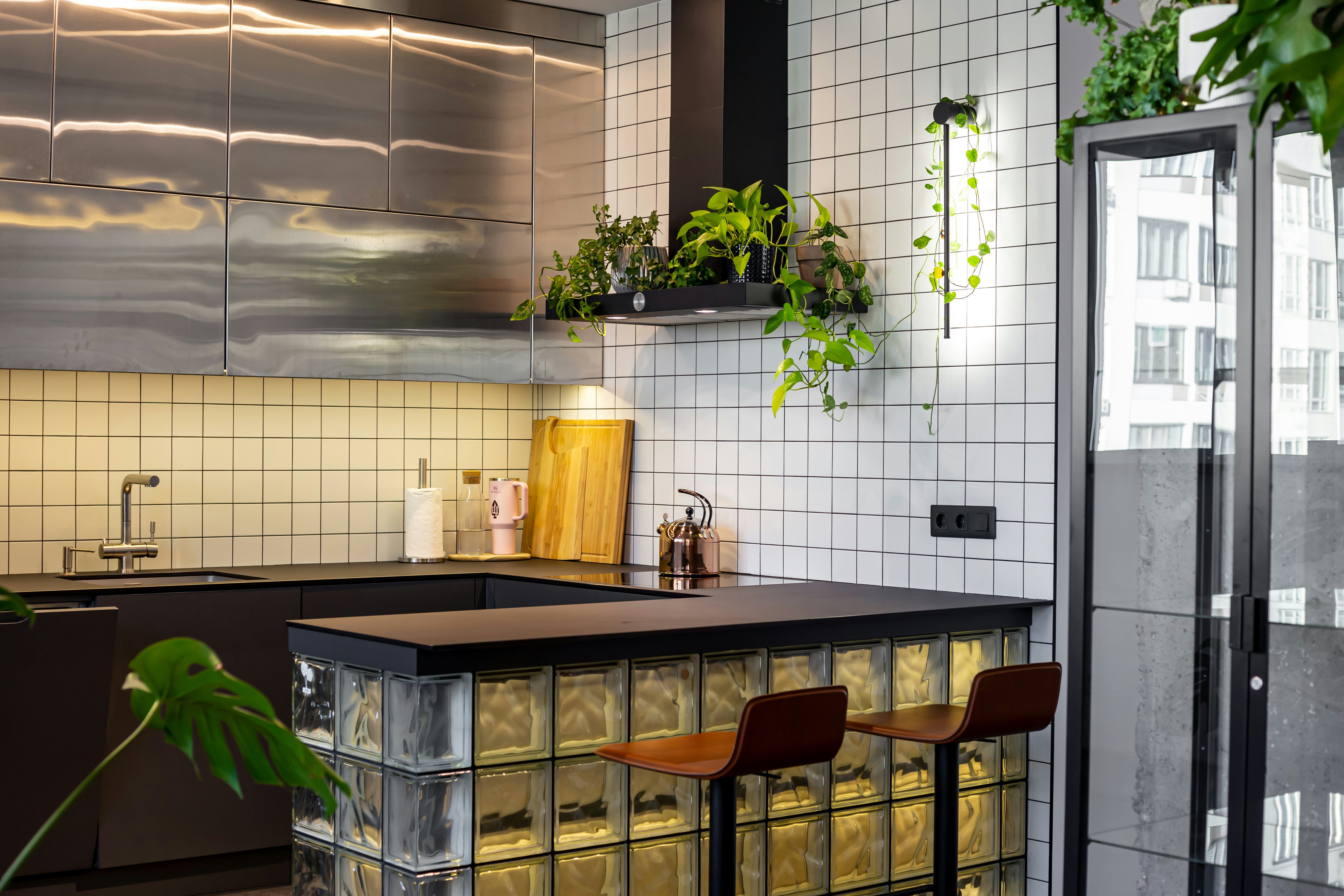 A sleek kitchen with a panel-ready built-in wine cooler that matches the surrounding dark wood cabinetry