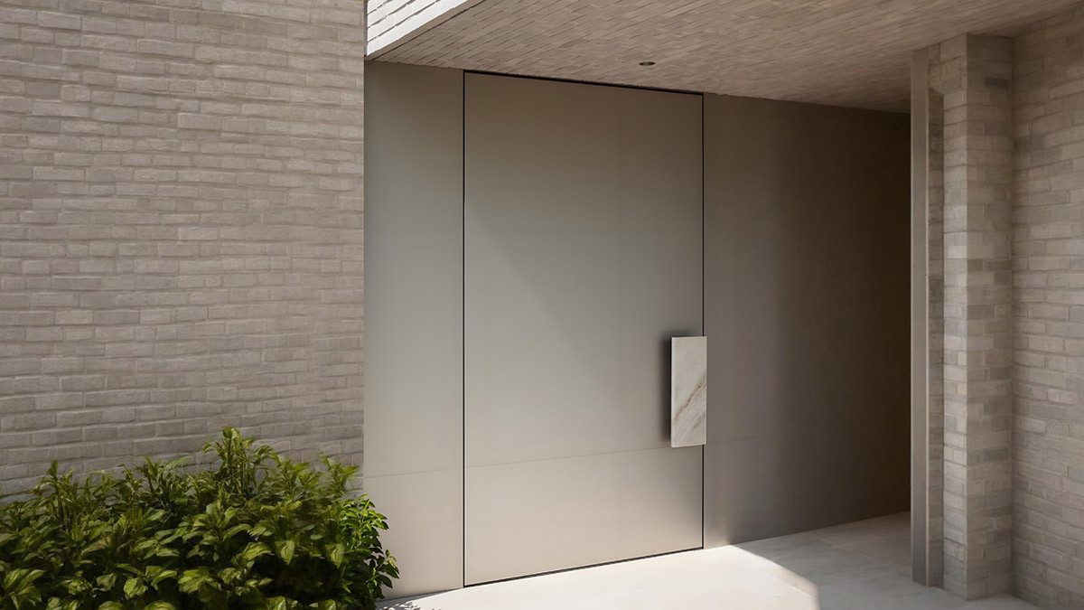 Taupe flush flat panel aluminum door in recessed stone entry