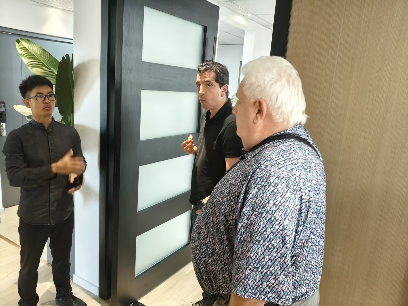 Delegation reviewing door and window samples at the BLOSSOM CHEER showroom