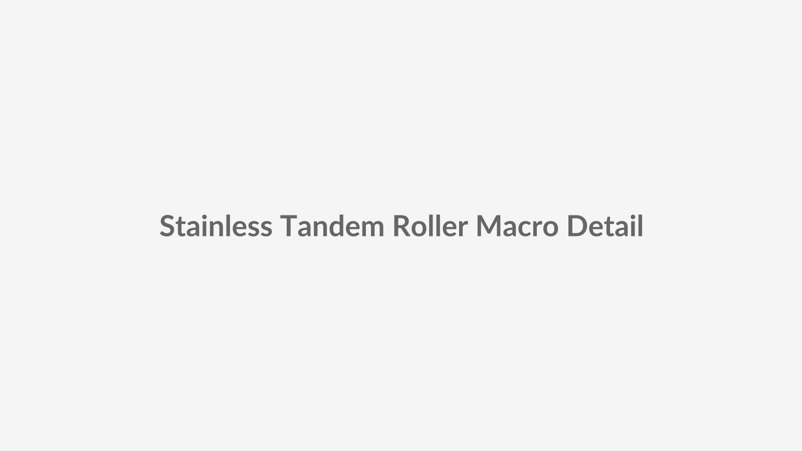 Macro product placeholder showing a stainless steel tandem roller assembly smoothly gliding along a sliding window track, highlighting sealed bearings, polished rail contact and precision hardware detailing