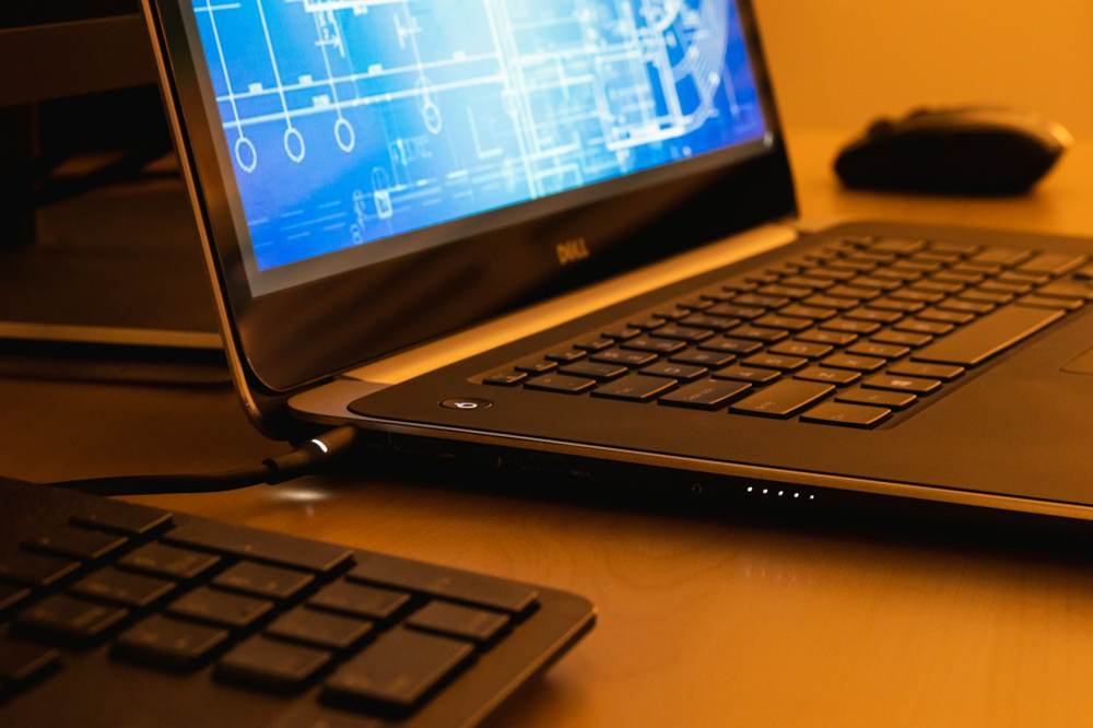 Laptop displaying a technical drawing on a desk