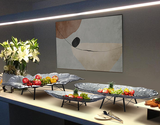Glass platters and fruit plates arranged on a hotel buffet table