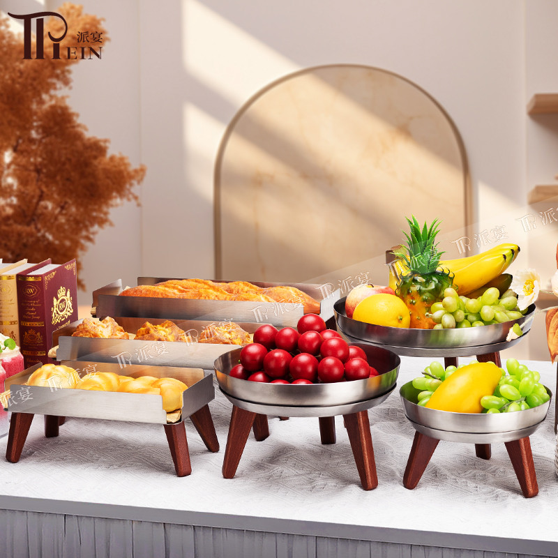 Buffet display stands with fruit bowls and trays arranged at different levels